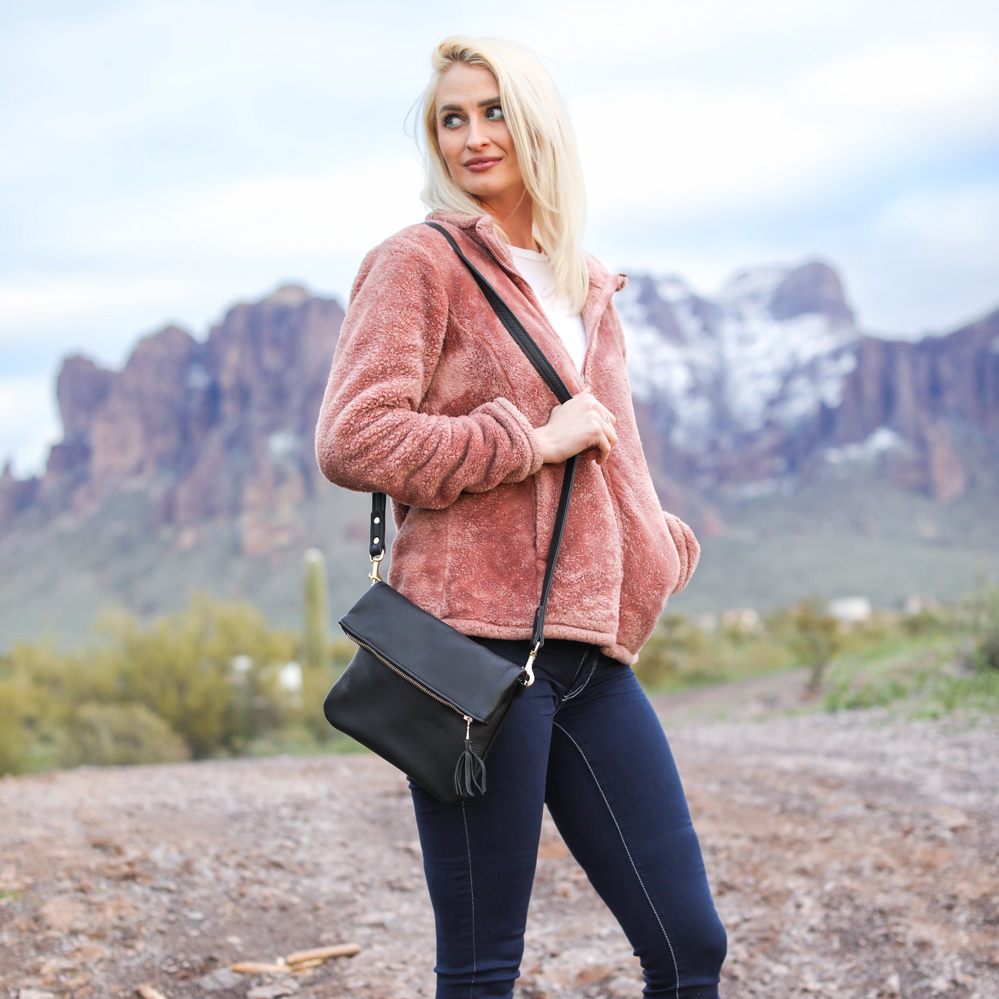 A stylish Foldover Crossbody Clutch made from premium American leather, featuring a zipper main pouch and a magnetic snap pocket.