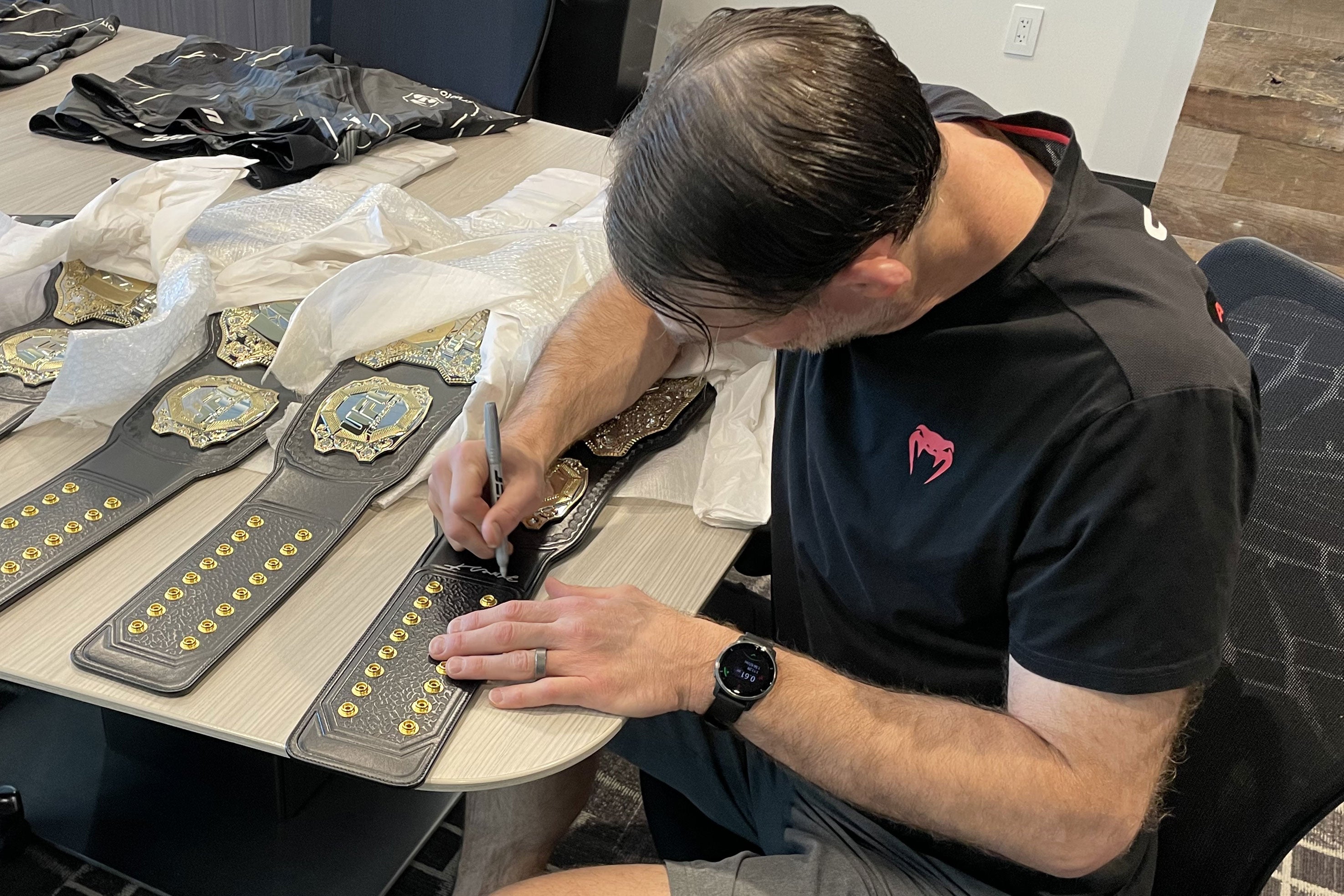 Forrest Griffin Signed UFC Replica Classic Championship Belt displayed elegantly, showcasing its detailed design and autograph.