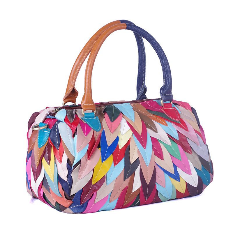 A stylish women's handbag featuring a geometric pattern and contrast colors, designed for modern use.