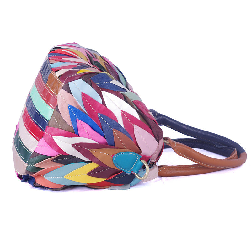 A stylish women's handbag featuring a geometric pattern and contrast colors, designed for modern use.