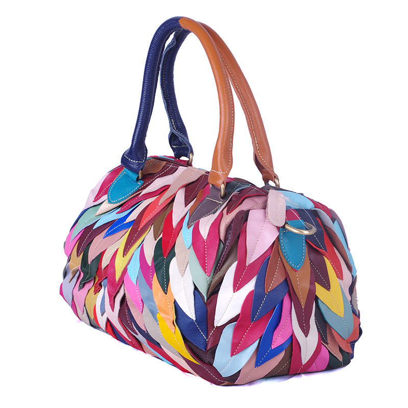 A stylish women's handbag featuring a geometric pattern and contrast colors, designed for modern use.