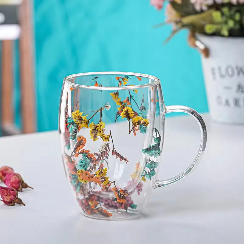 A set of Gorgeous High End Borosilicate Glass Cups with Handle featuring floral and shell designs, showcasing their elegant round shape and transparent glass.