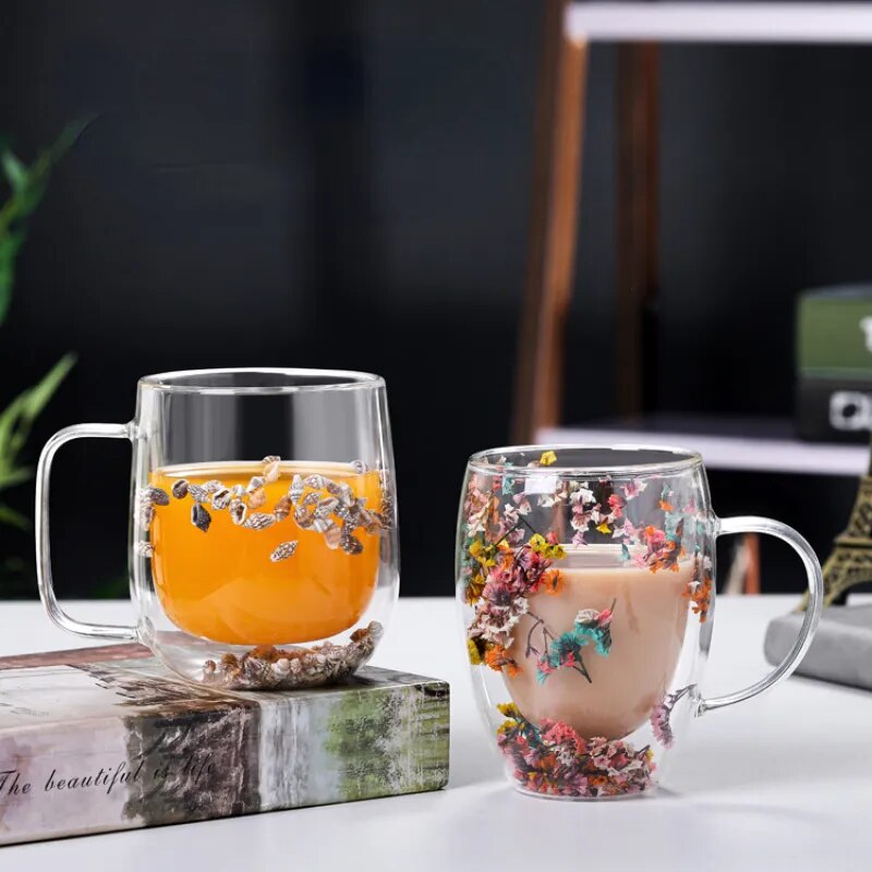 A set of Gorgeous High End Borosilicate Glass Cups with Handle featuring floral and shell designs, showcasing their elegant round shape and transparent glass.