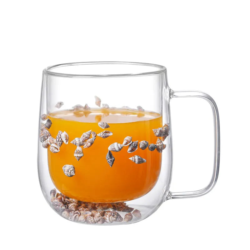 A set of Gorgeous High End Borosilicate Glass Cups with Handle featuring floral and shell designs, showcasing their elegant round shape and transparent glass.