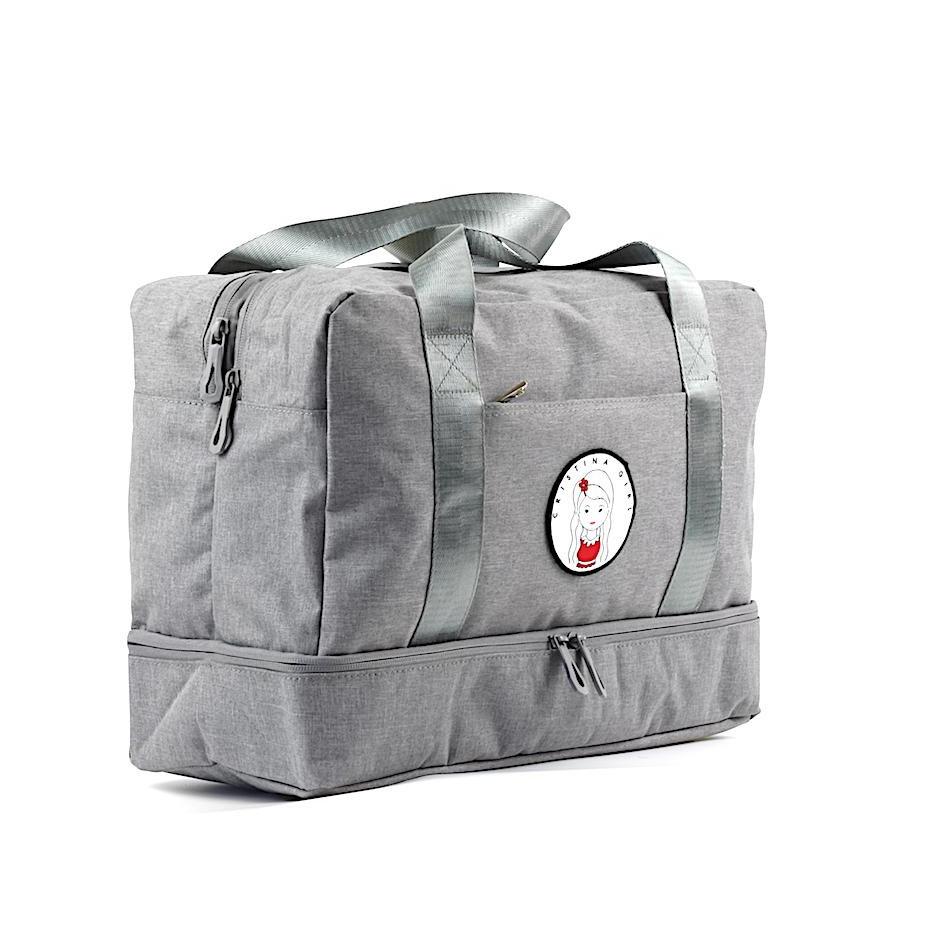 A spacious gym bag with a shoe compartment, featuring multiple zipped pockets and a stylish design, perfect for workouts and travel.