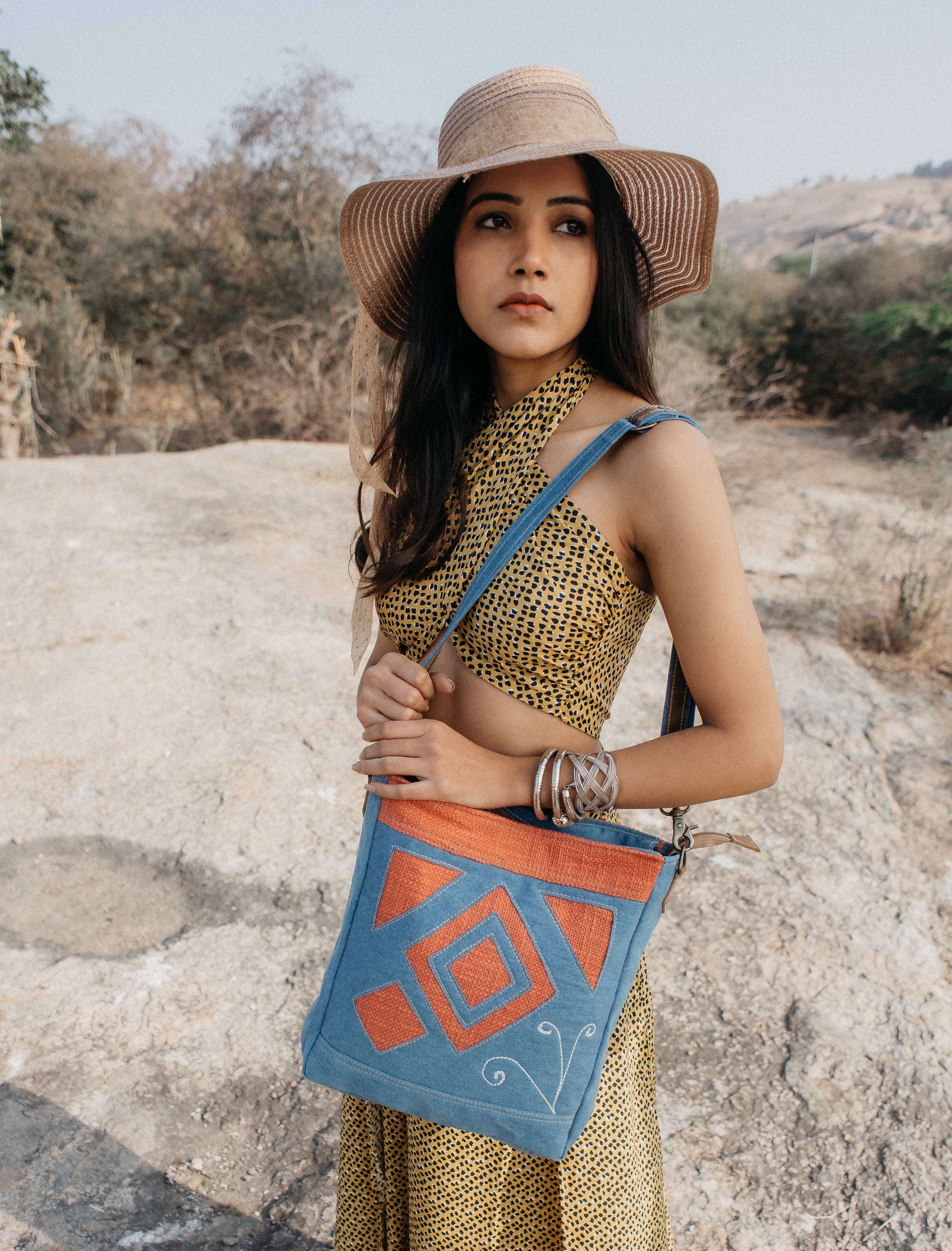 Gyur Shoulder Bag made of high-quality blue denim canvas with adjustable straps, showcasing its stylish and casual design.