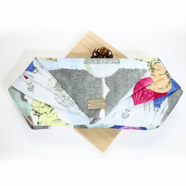 A stylish hand-drawn printed clutch featuring unique artistic designs, perfect for any occasion.