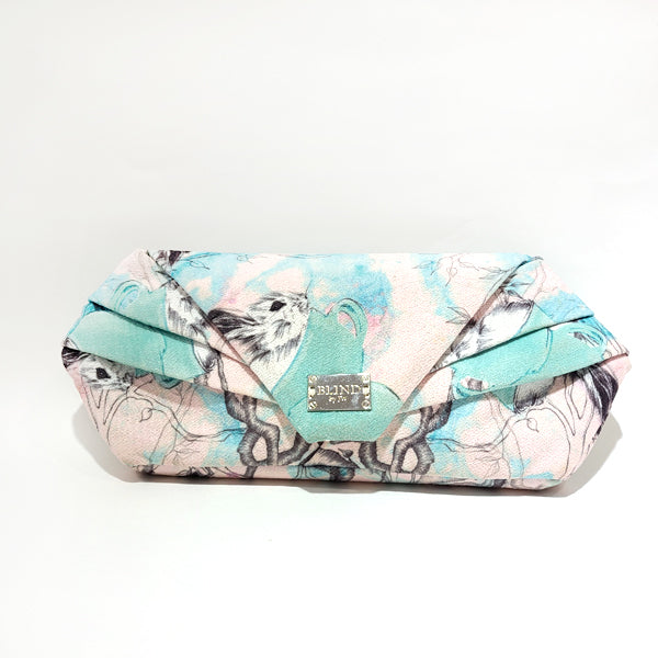 A stylish hand-drawn printed clutch featuring unique artistic designs, perfect for any occasion.