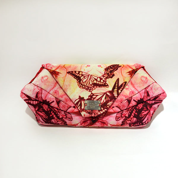 A stylish hand-drawn printed clutch featuring unique artistic designs, perfect for any occasion.