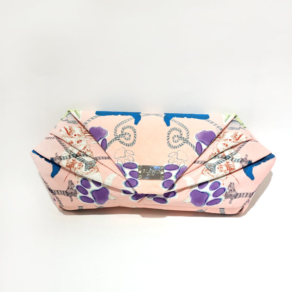 A stylish hand-drawn printed clutch featuring unique artistic designs, perfect for any occasion.