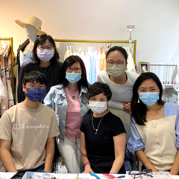 Participants creating unique handcrafted earrings with semi-precious gemstones and glass beads at La Paz HK workshop.