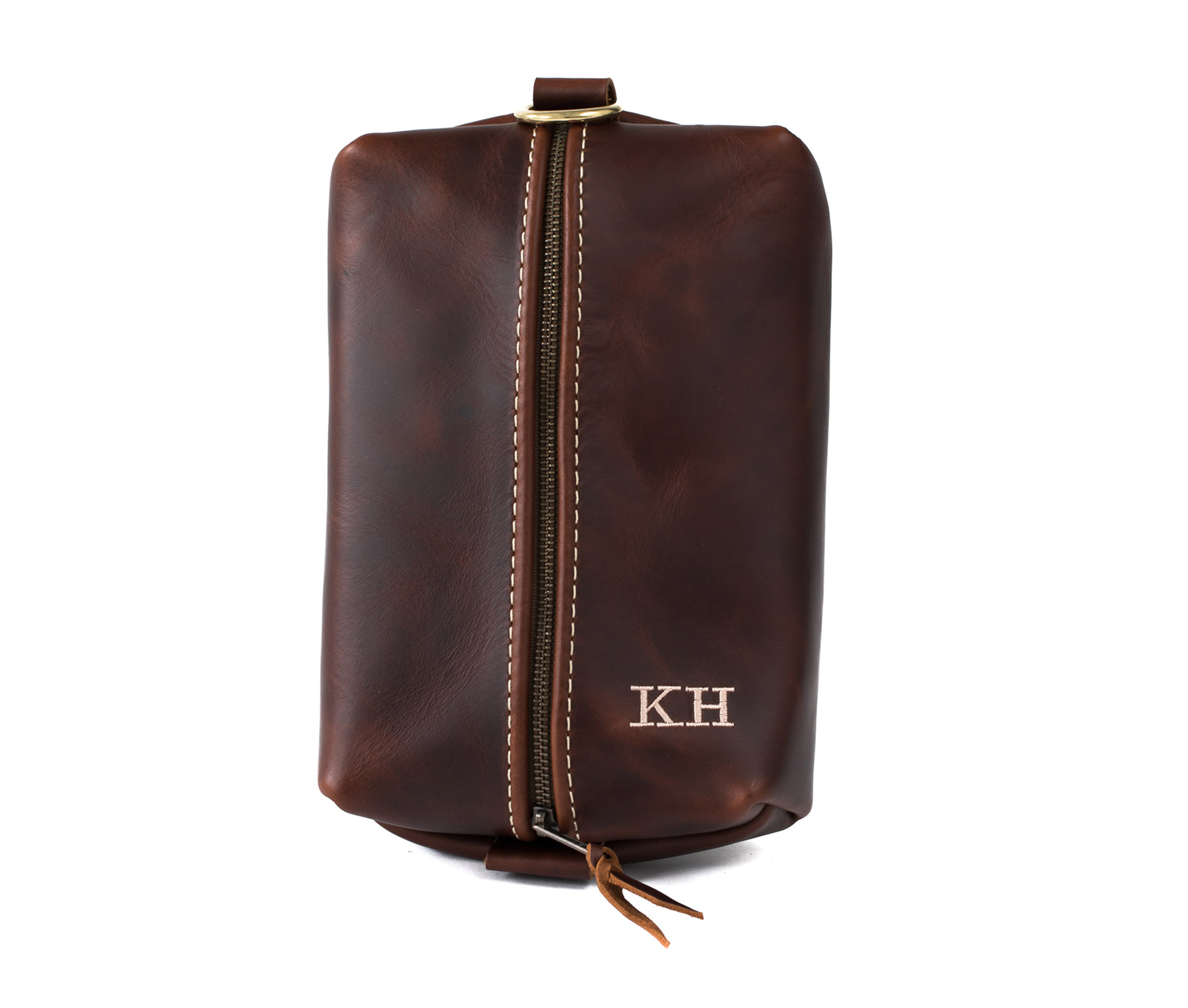 Heirloom Toiletry Bag made of full grain leather with a spacious interior and heavy-duty zipper, featuring a water-resistant nylon liner.