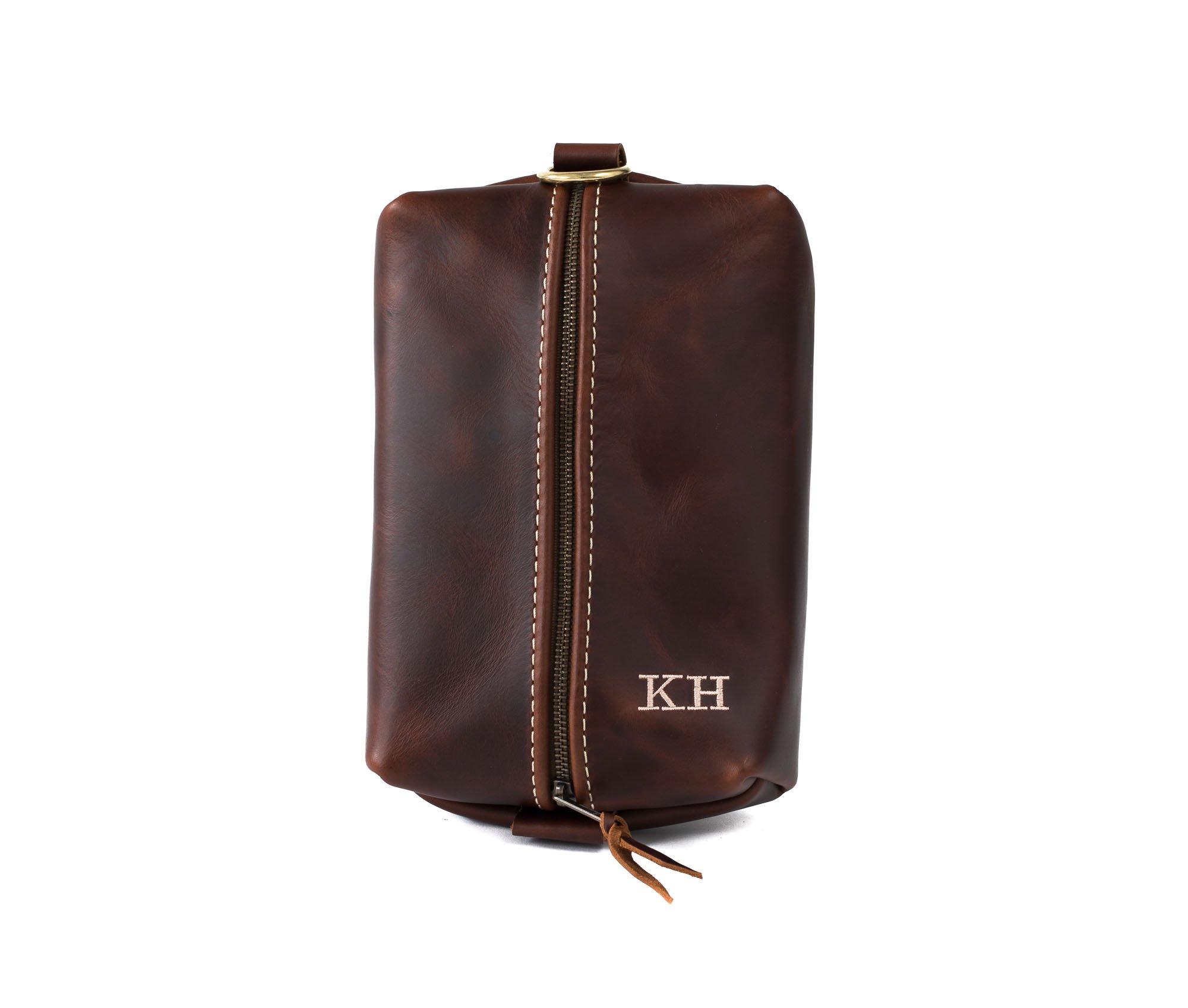 Heirloom Toiletry Bag made of full grain leather with a spacious interior and heavy-duty zipper, featuring a water-resistant nylon liner.