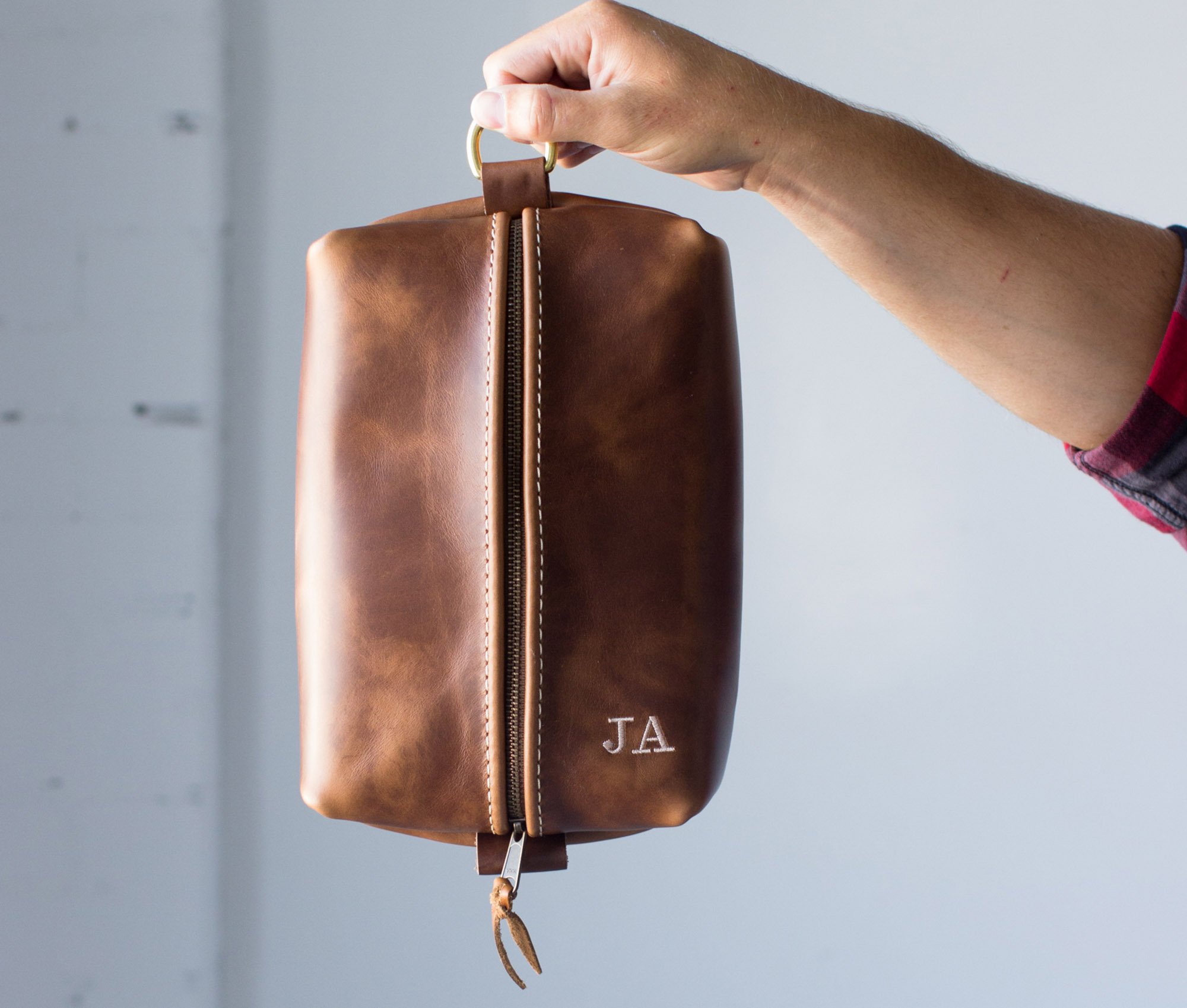 Heirloom Toiletry Bag made of full grain leather with a spacious interior and heavy-duty zipper, featuring a water-resistant nylon liner.