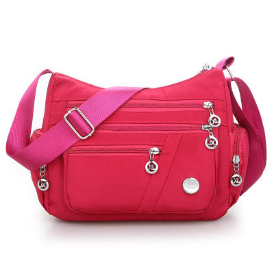 High Quality Nylon Fabric Women's Messenger Bag in dumpling shape, featuring a zipper opening and multiple pockets, perfect for stylish everyday use.