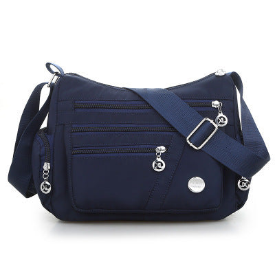 High Quality Nylon Fabric Women's Messenger Bag in dumpling shape, featuring a zipper opening and multiple pockets, perfect for stylish everyday use.