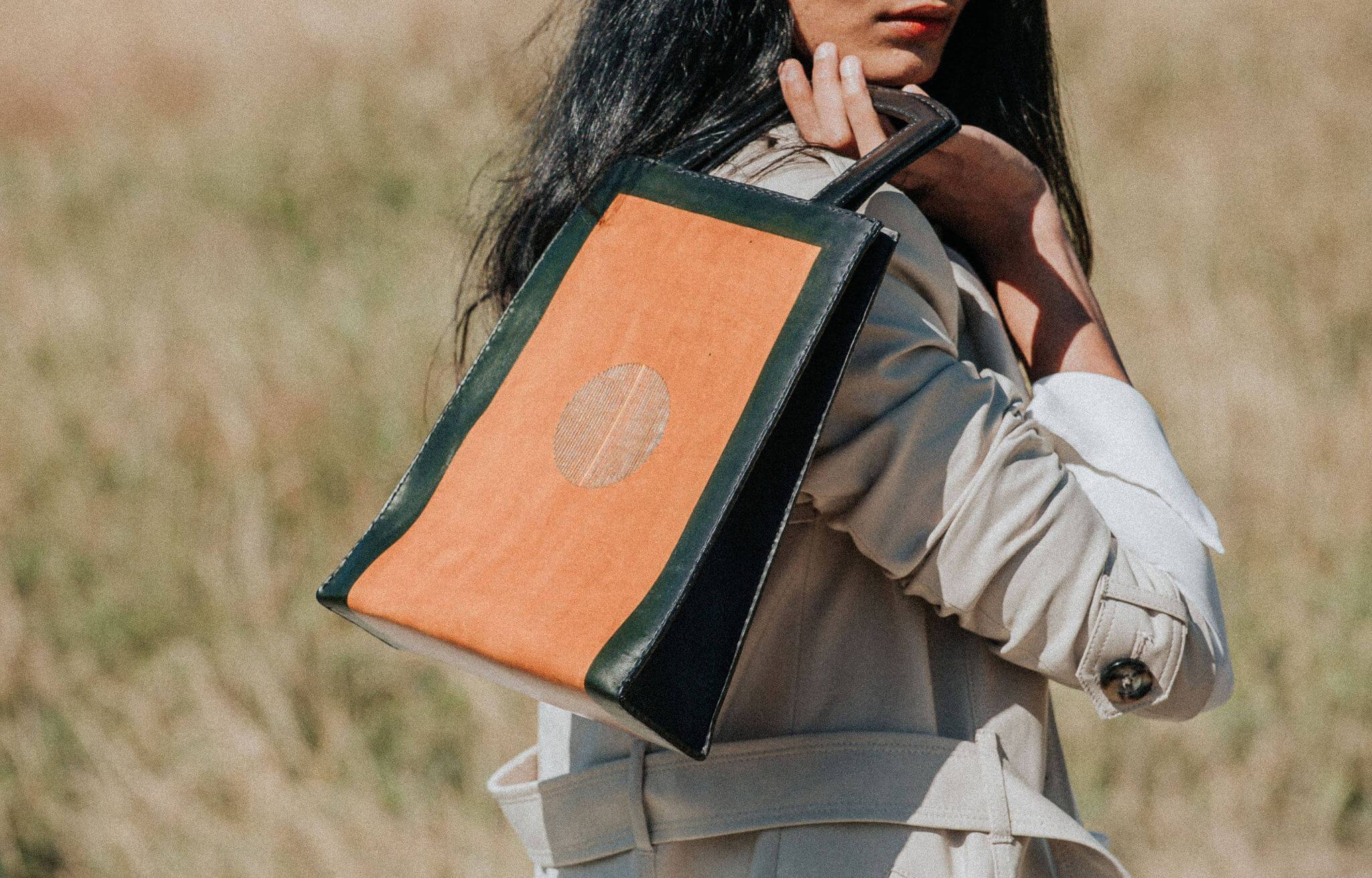 A stylish IGNIS Tote made from 100% natural vegetable-tanned leather, showcasing its unique design inspired by fire and sand.