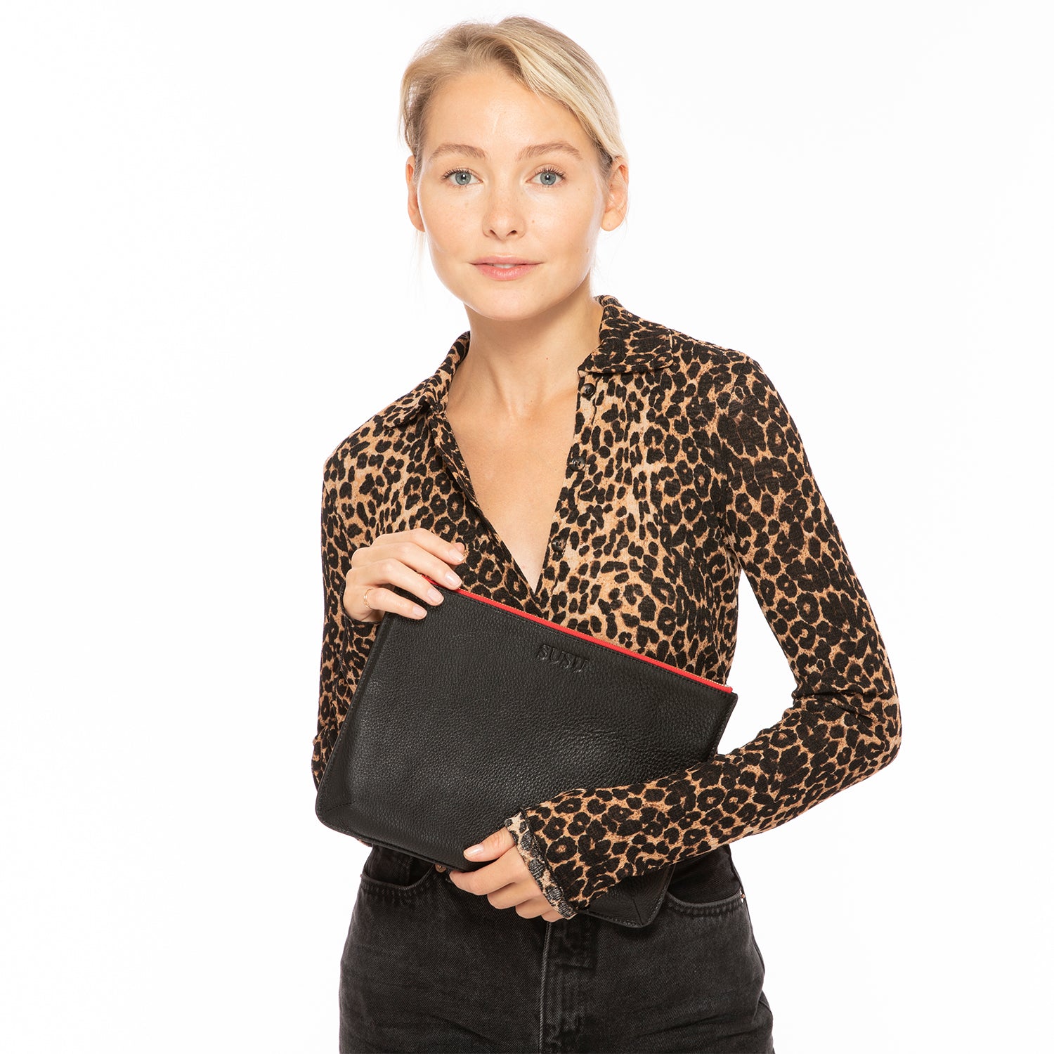 Elegant black leather iPad clutch case with pebbled texture, designed to protect and stylishly carry your iPad.