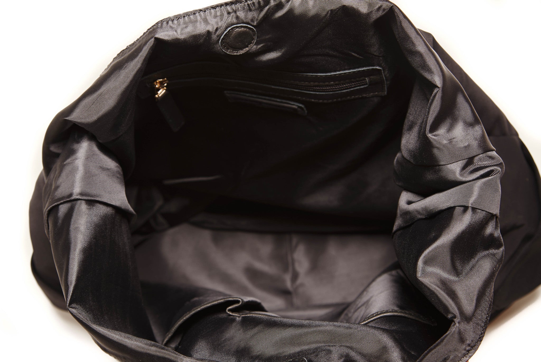 Jacki Easlick Black oversized hobo bag featuring cowhide leather trim and waterproof nylon material, ideal for travel and everyday use.