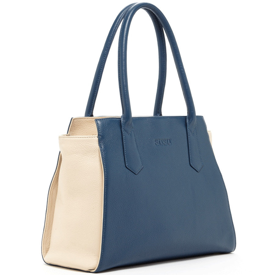 Jody Blue Ivory Leather Tote Bag featuring a two-tone design with light gold hardware and a spacious interior.