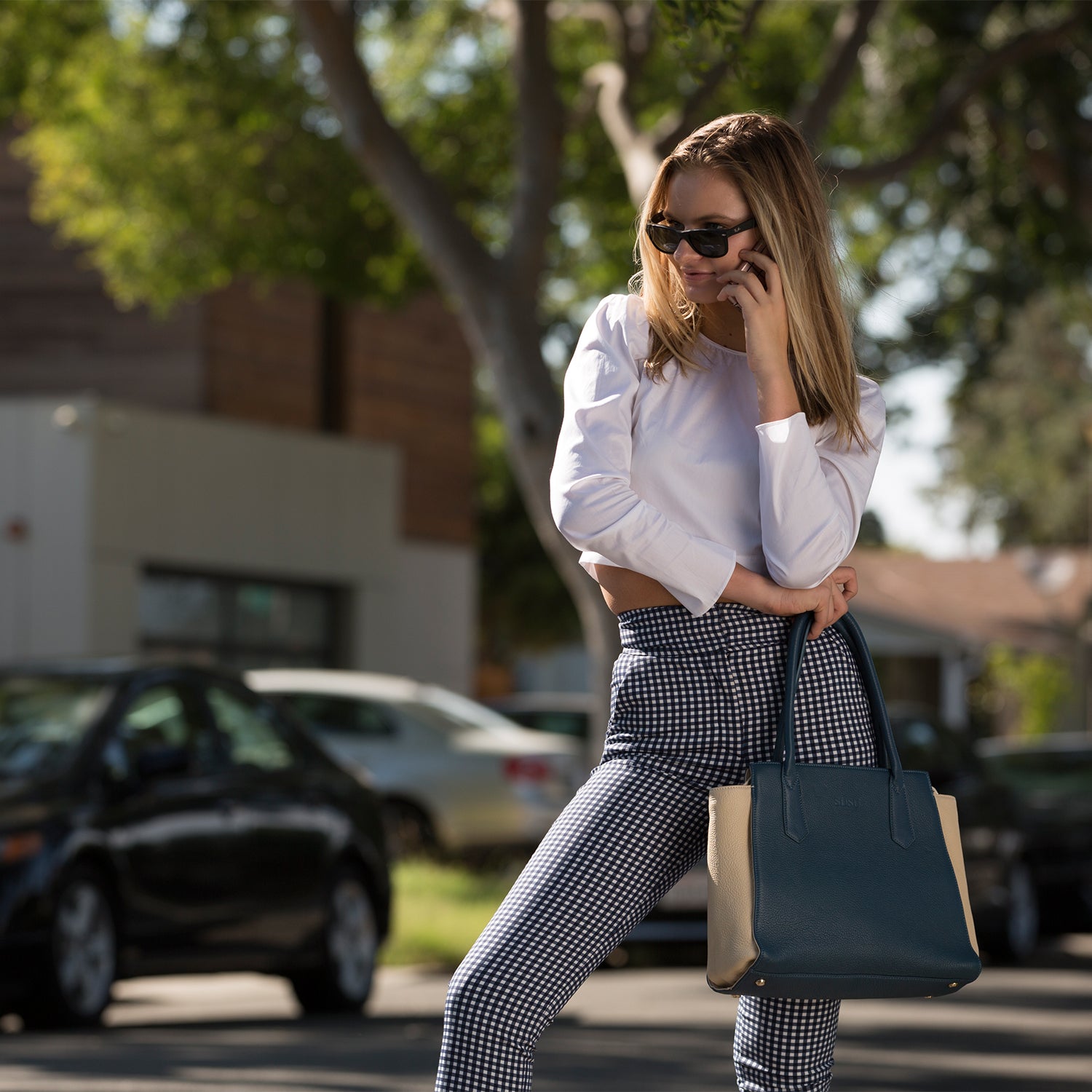 Jody Blue Ivory Leather Tote Bag featuring a two-tone design with light gold hardware and a spacious interior.