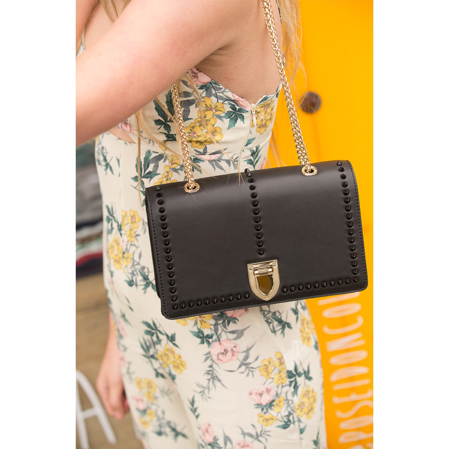 Josie Black Leather Chain Bag featuring decorative studs and a gold chain strap, perfect for stylish outings.