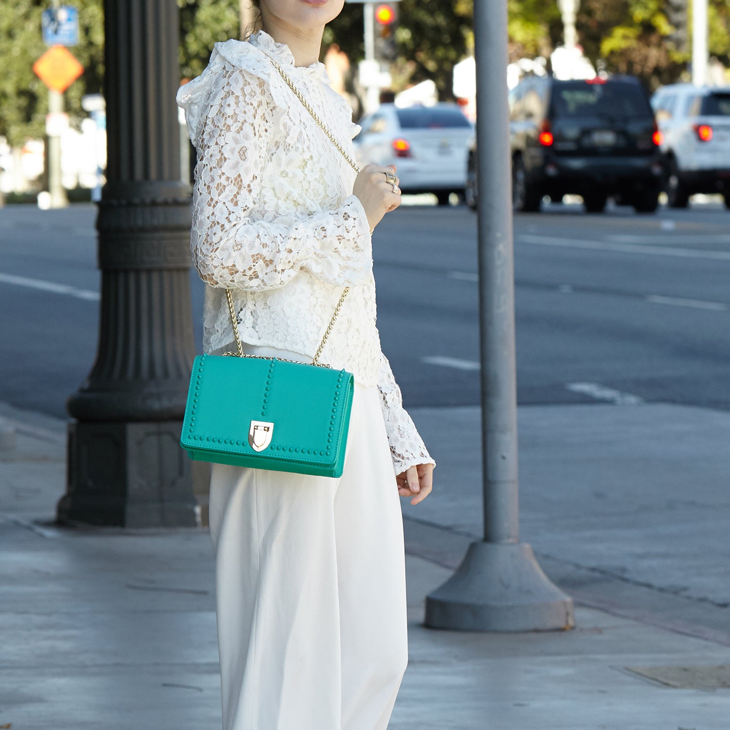 Josie Green Leather Bag with Chain Strap featuring decorative studs and a stylish design.