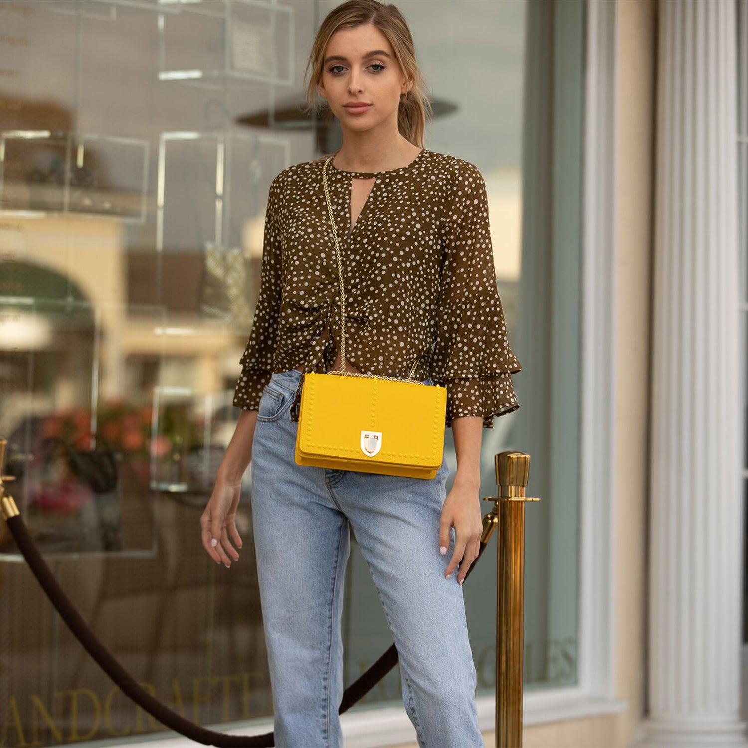 Josie Mustard Yellow Leather Purse with decorative studs and gold chain strap, showcasing its stylish design and functional features.