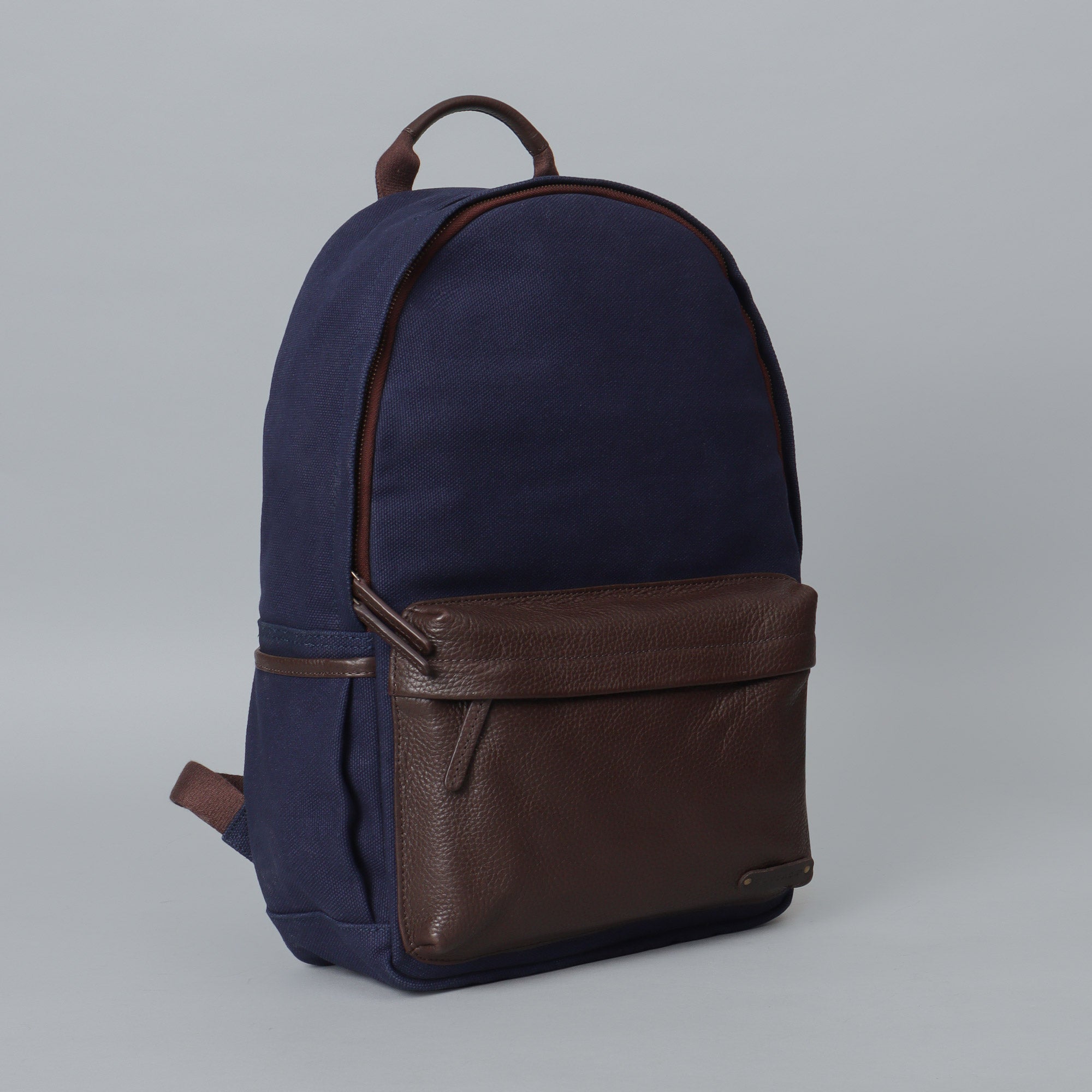 Journey Canvas Backpack featuring padded laptop section, multiple pockets, and adjustable straps, made from durable water-resistant cotton canvas.