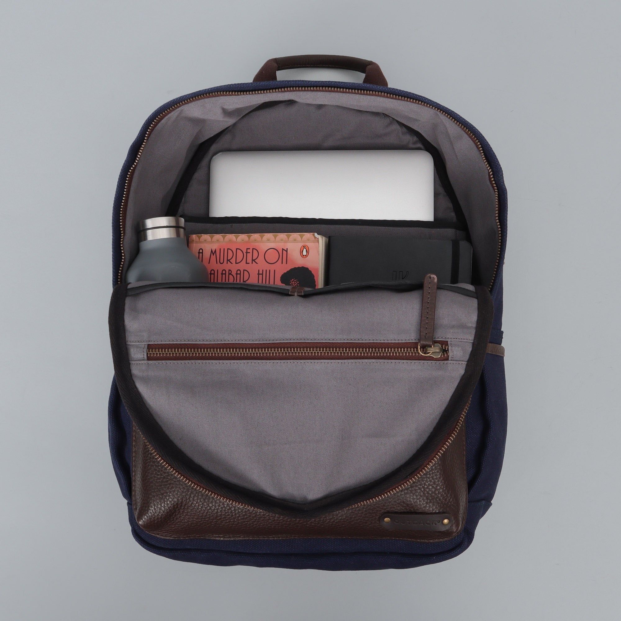 Journey Canvas Backpack featuring padded laptop section, multiple pockets, and adjustable straps, made from durable water-resistant cotton canvas.