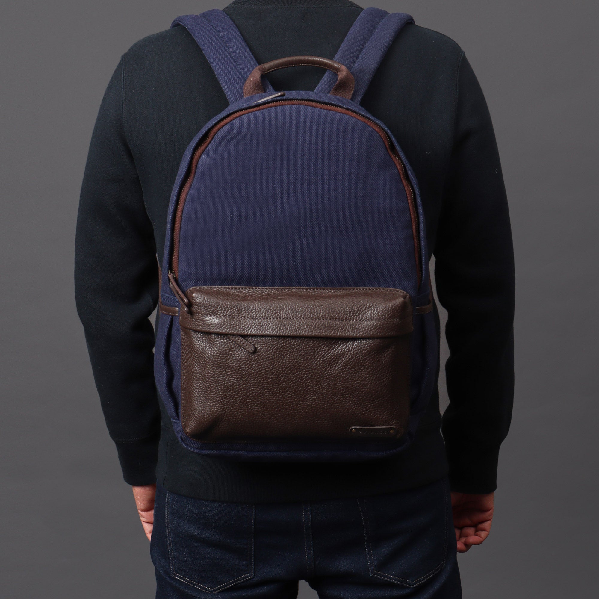 Journey Canvas Backpack featuring padded laptop section, multiple pockets, and adjustable straps, made from durable water-resistant cotton canvas.