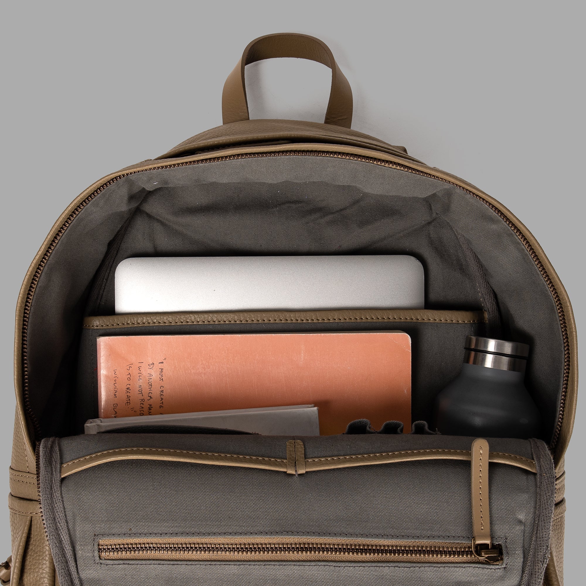 Journey Leather Backpack made from premium full grain leather with multiple pockets and padded laptop compartment.