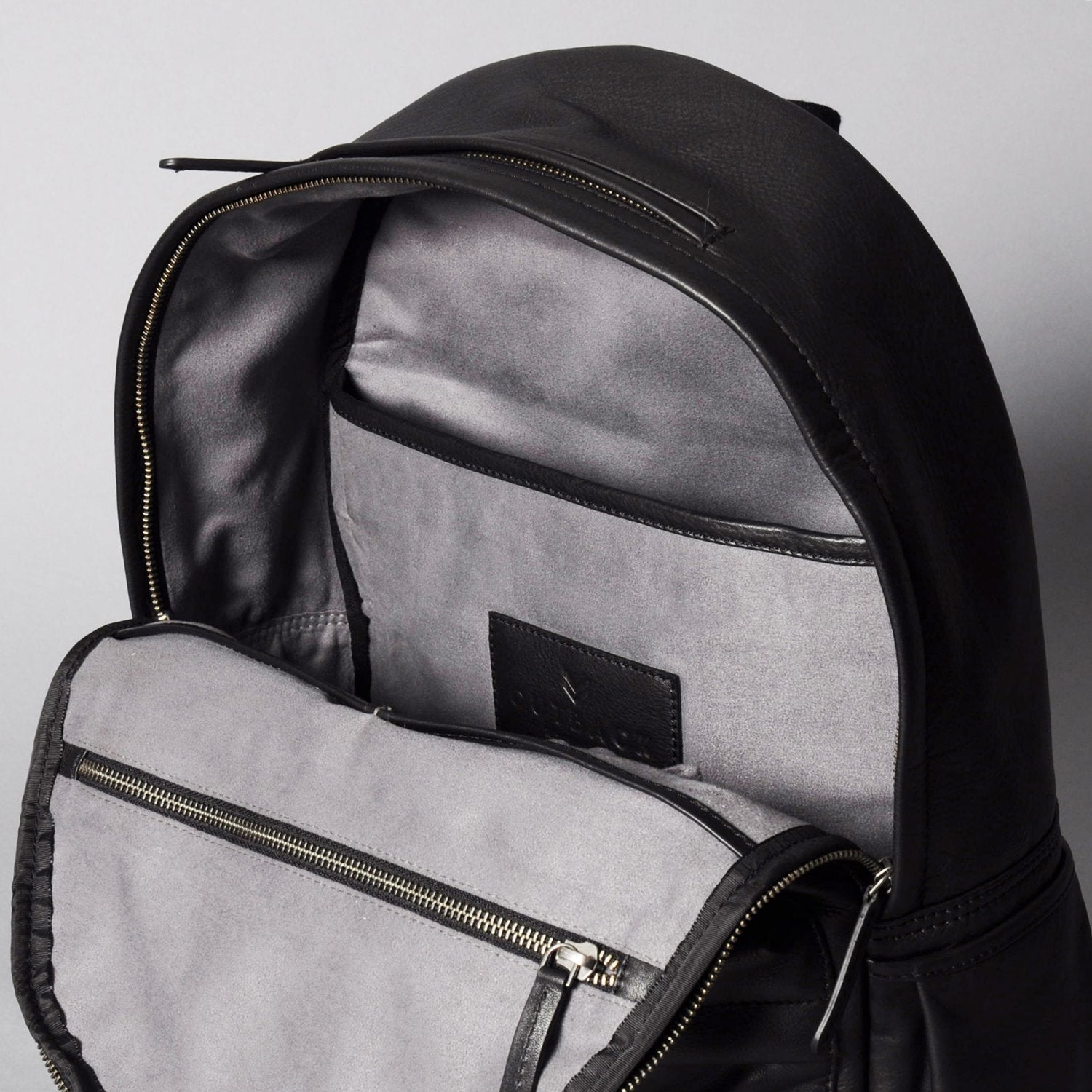 A stylish Journey Leather Backpack made from premium full grain leather, featuring multiple pockets and a padded laptop compartment.