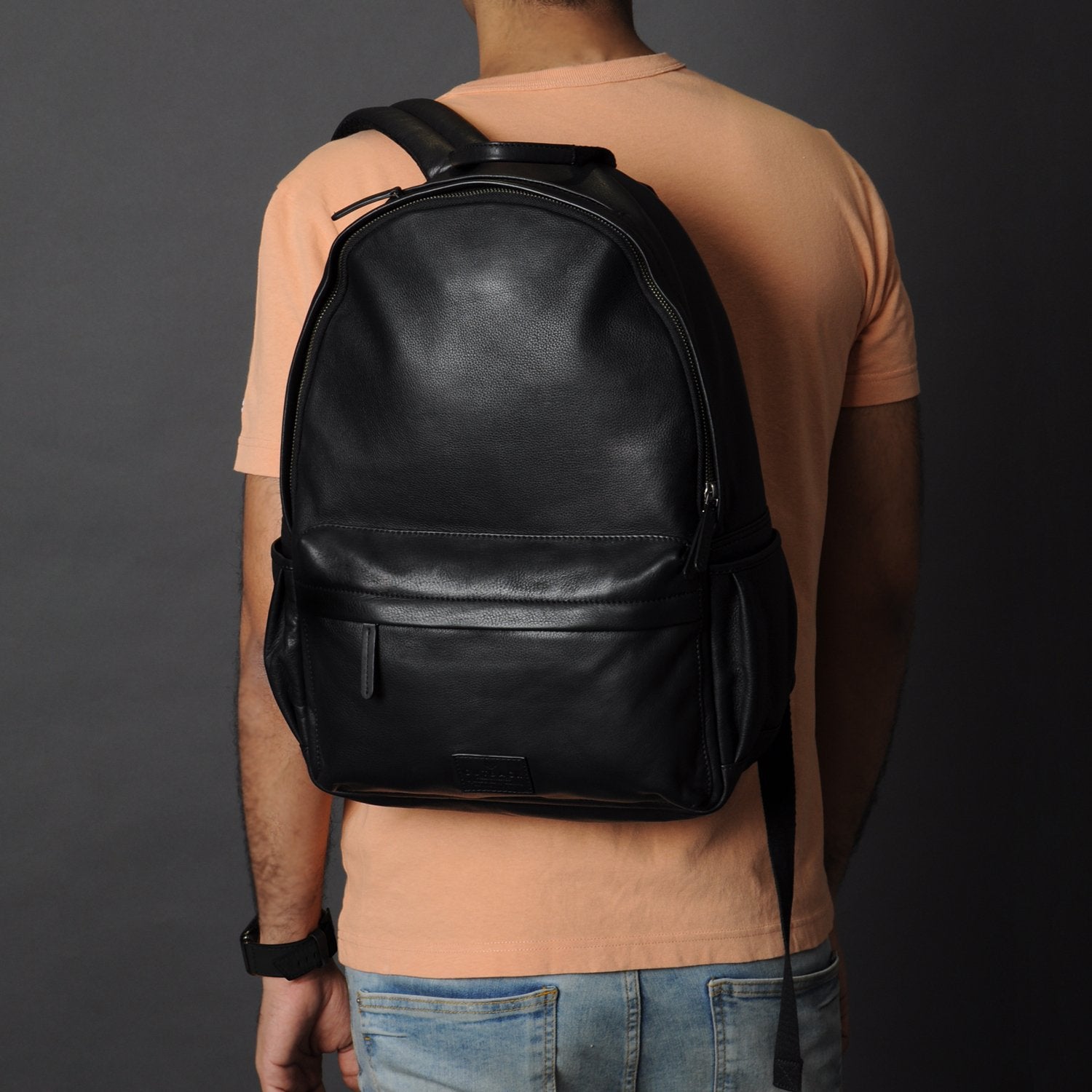 A stylish Journey Leather Backpack made from premium full grain leather, featuring multiple pockets and a padded laptop compartment.