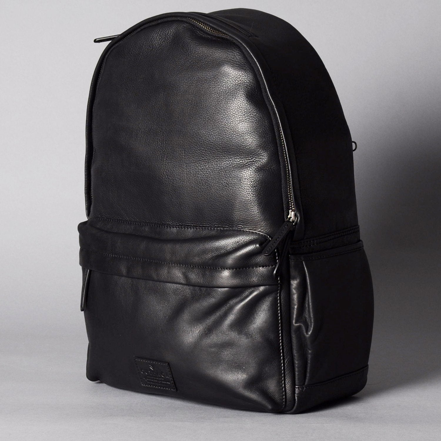 A stylish Journey Leather Backpack made from premium full grain leather, featuring multiple pockets and padded straps for comfort.