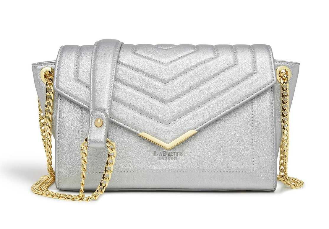 Kensington Silver Vegan Cross Body Bag with double gold chain strap and V-shape quilting design.