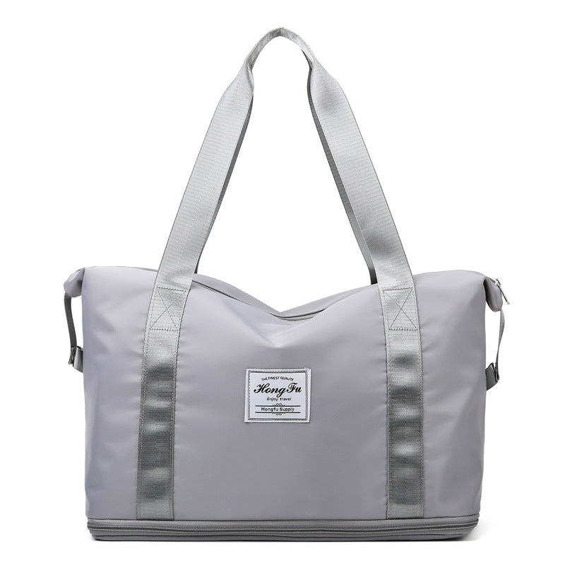 Korean style female short-distance portable travel bag in nylon, featuring a soft handle and square vertical section design.