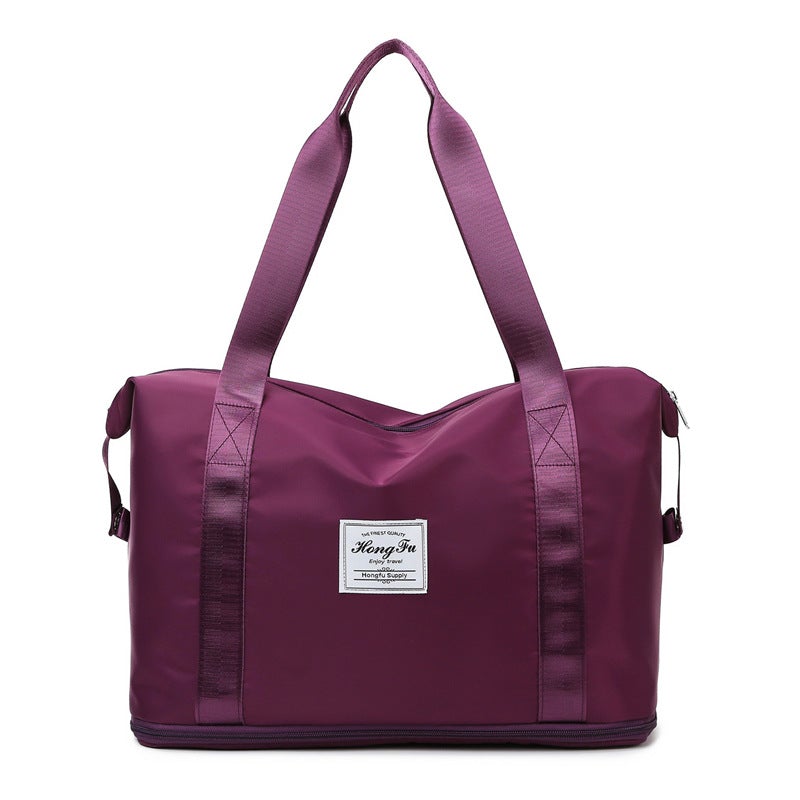 Korean style female short-distance portable travel bag in nylon, featuring a soft handle and square vertical section design.