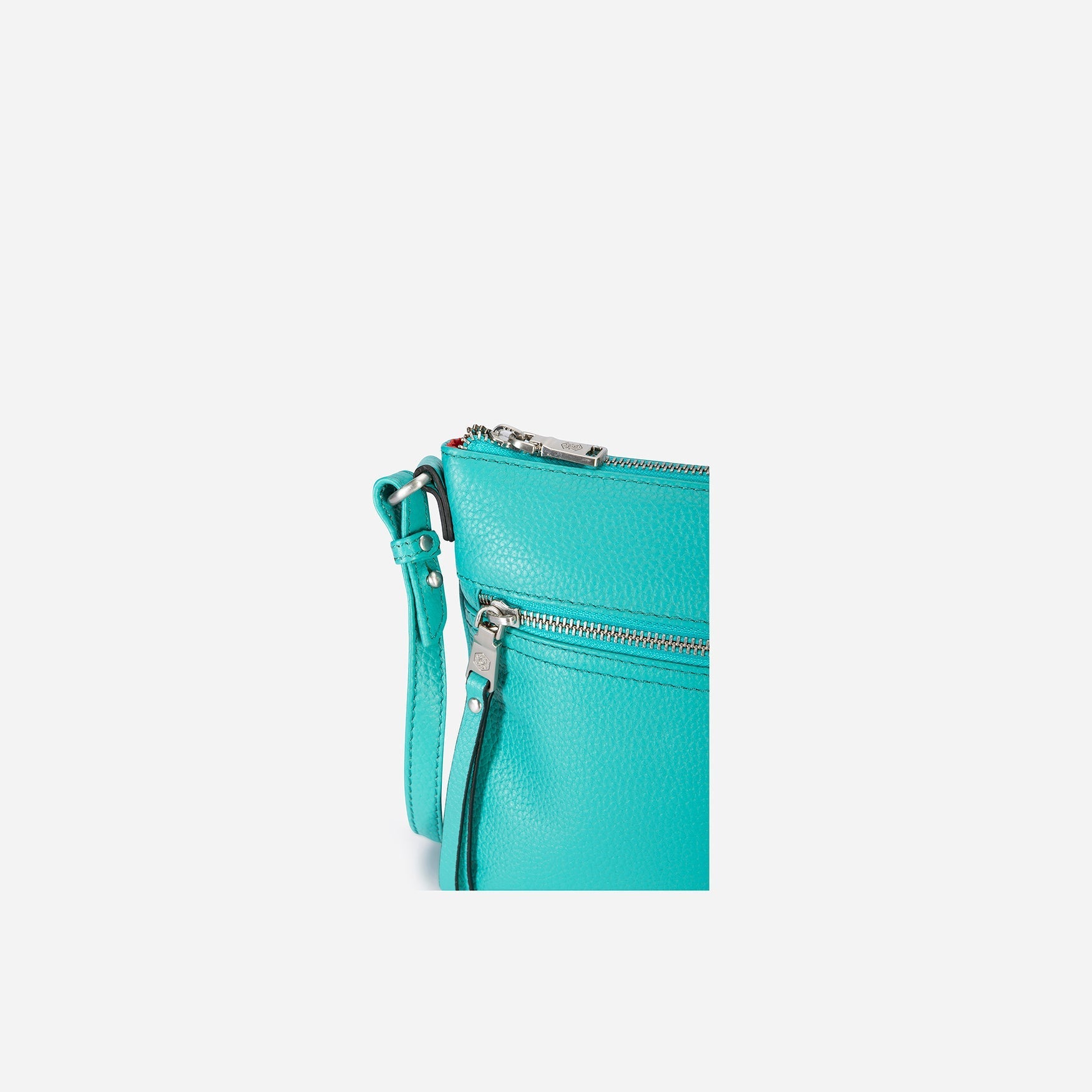 Ladies Crossbody bag in Calypso Teal with adjustable straps and RFID protection, showcasing its stylish design and spacious interior.