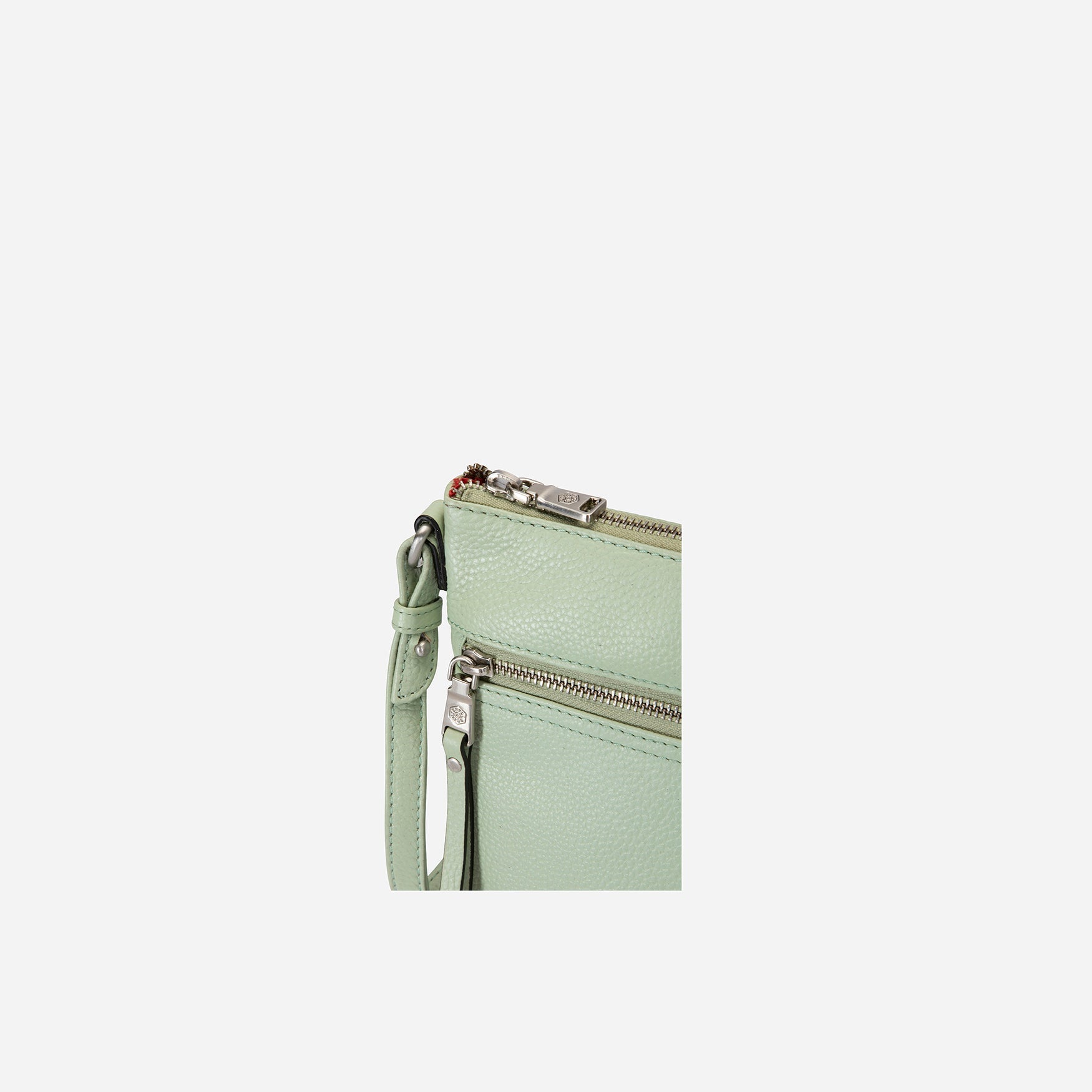 Ladies Crossbody bag in sage green with adjustable straps and RFID protection, showcasing its stylish design and spacious interior.