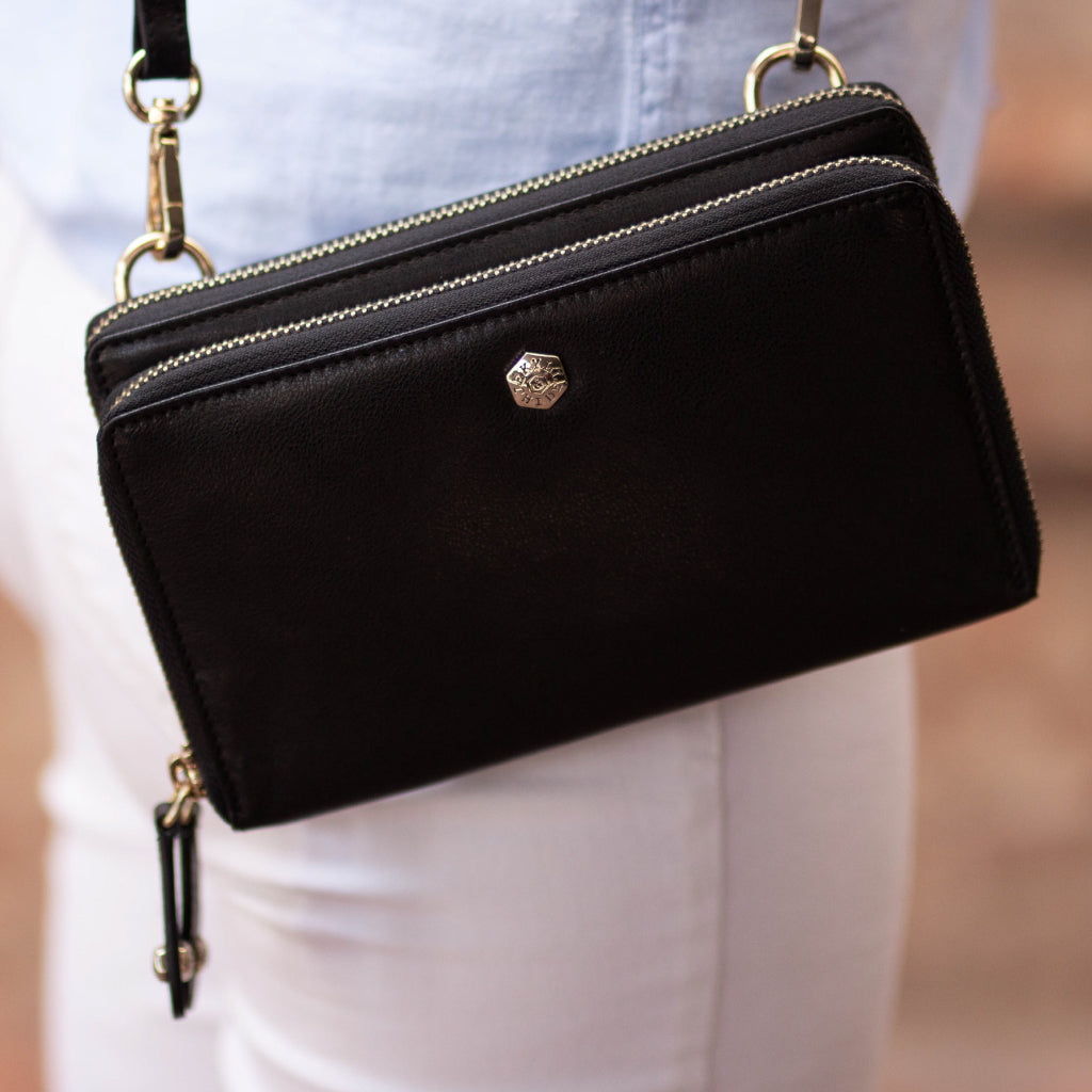 Elegant black ladies purse with a detachable strap, showcasing its stylish design and spacious interior.