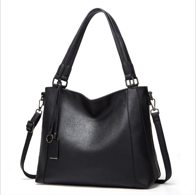 Ladies Soft Leather Portable Fashion Casual Messenger Bag in soft PU leather with a bucket shape and zipper opening, featuring multiple internal pockets.