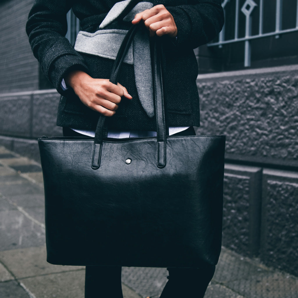 Large black laptop shopper bag with spacious interior and comfortable straps, perfect for carrying laptops and essentials.