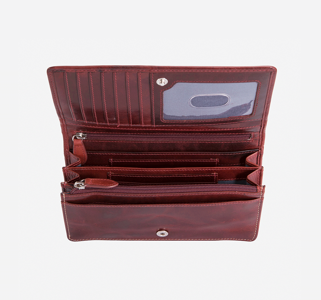 Large rust-colored leather purse with concertina design, showcasing its spacious interior and elegant finish.