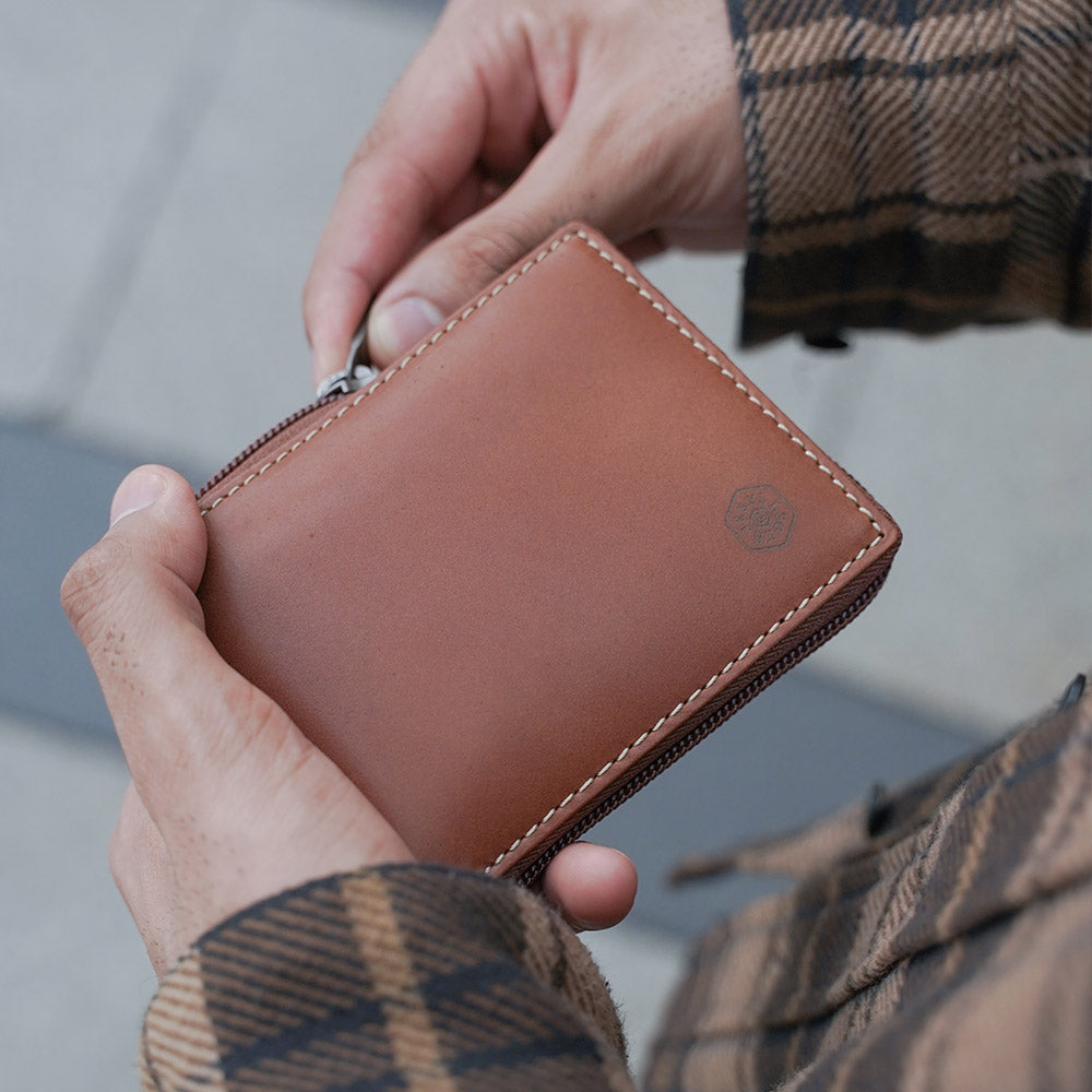 Large zip around wallet in clay color with coin pocket and ID window, designed for men.