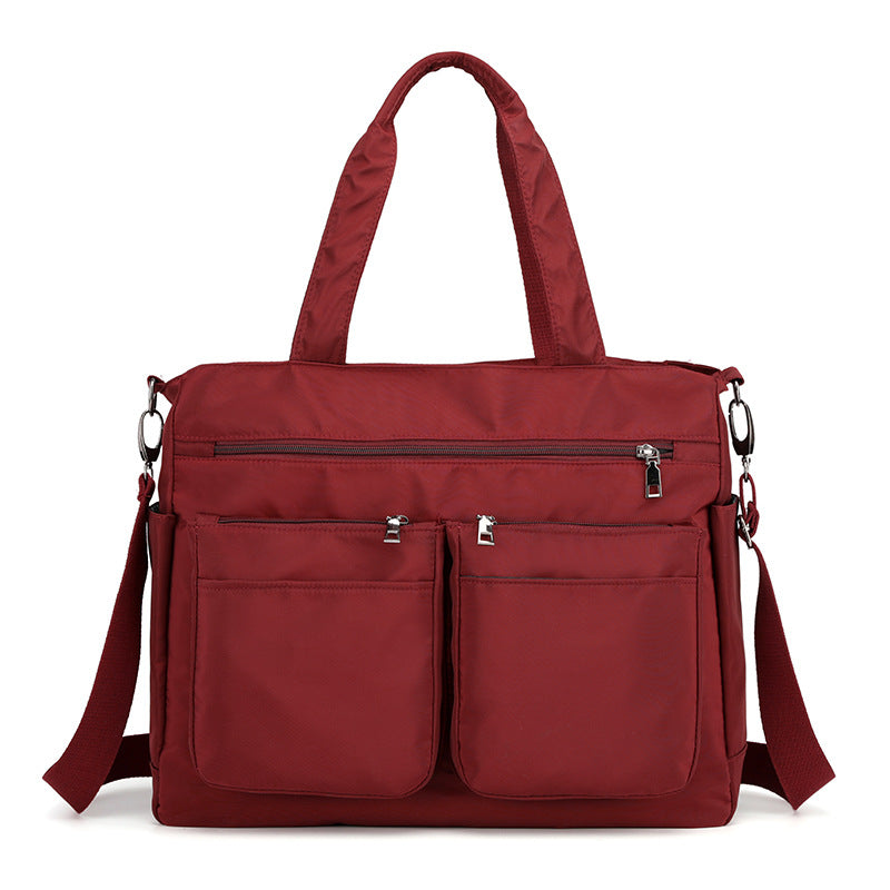 Large-capacity Lady's Oxford Cloth Messenger Bag in stylish design, featuring multiple pockets and zipper closure, perfect for daily use.