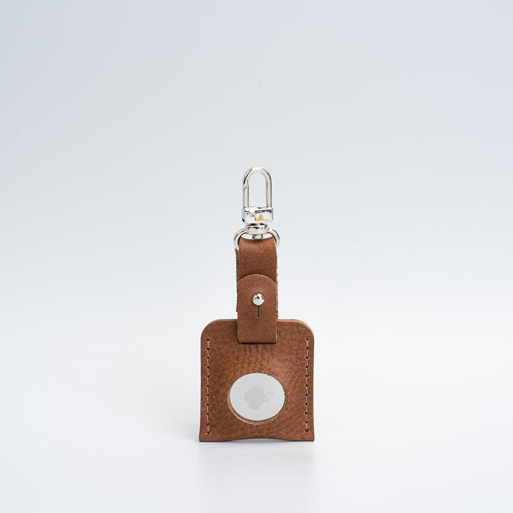 A stylish leather AirTag bag charm featuring a carabiner, handcrafted from premium Italian leather in various colors.