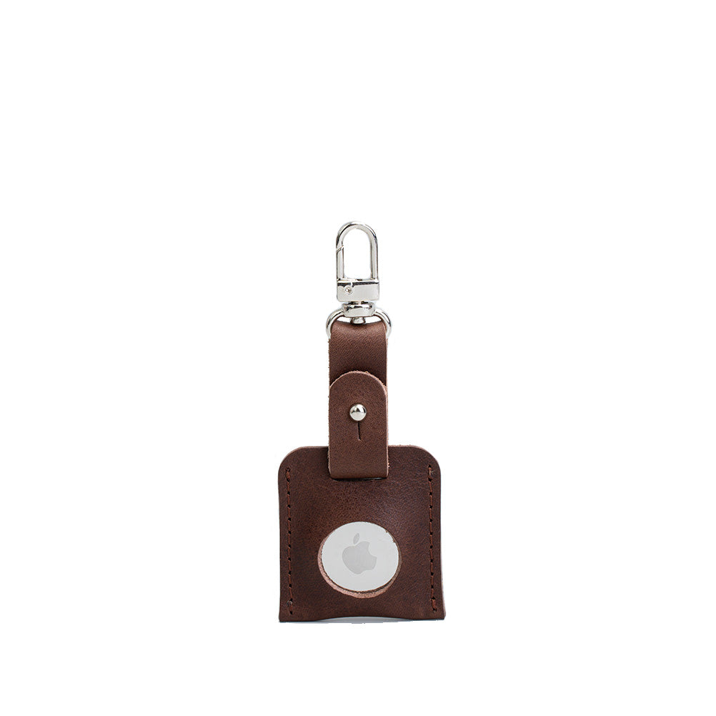 A stylish leather AirTag bag charm featuring a carabiner, handcrafted from premium Italian leather in various colors.