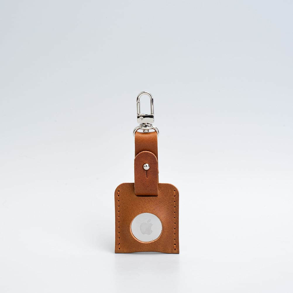 A stylish leather AirTag bag charm featuring a carabiner, handcrafted from premium Italian leather in various colors.