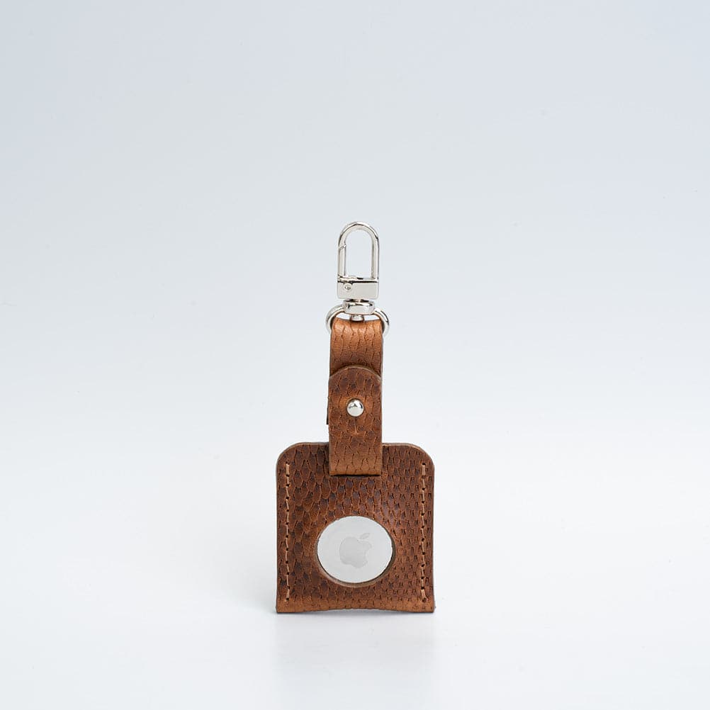 A stylish leather AirTag bag charm featuring a carabiner, handcrafted from premium Italian leather in various colors.